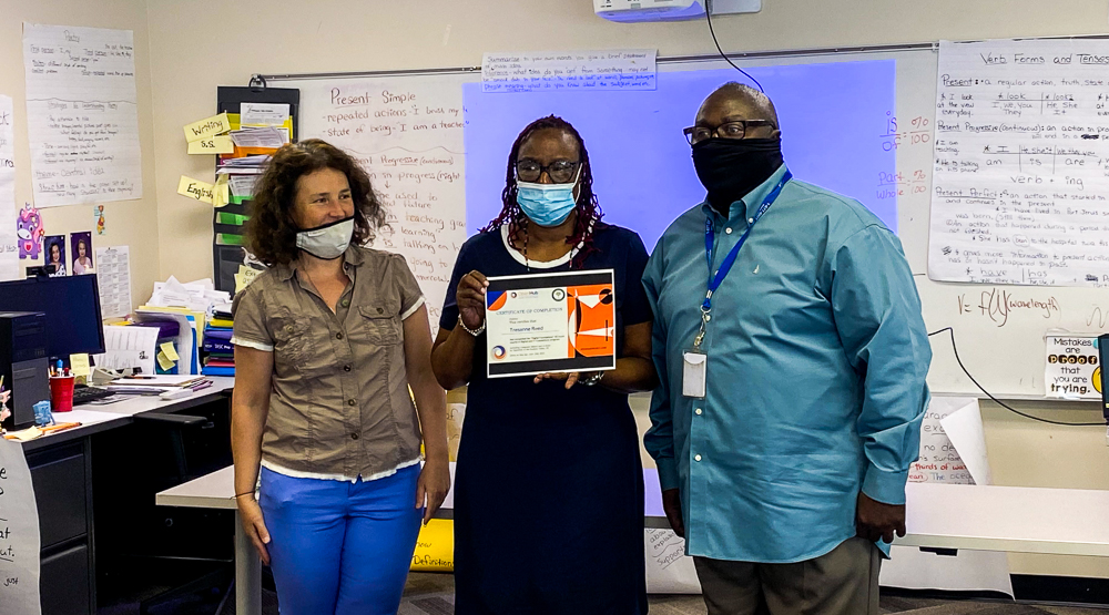 student posing proudly with a certificate